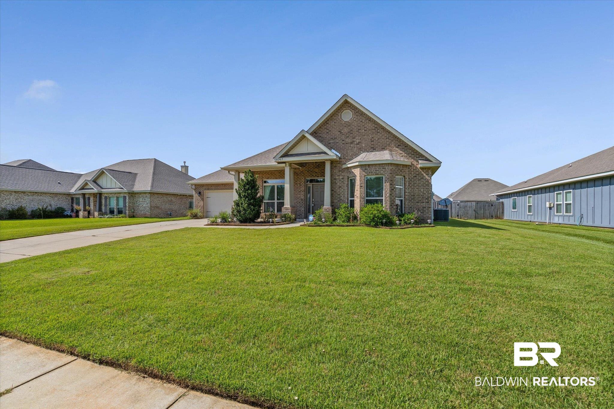 10207 Dunleith Loop Daphne, AL 36526 - Photo 20 of 23 Craftsman house with a front yard, brick siding, a garage, driveway, and a residential view