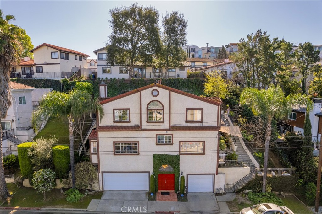 a front view of a house with a garden
