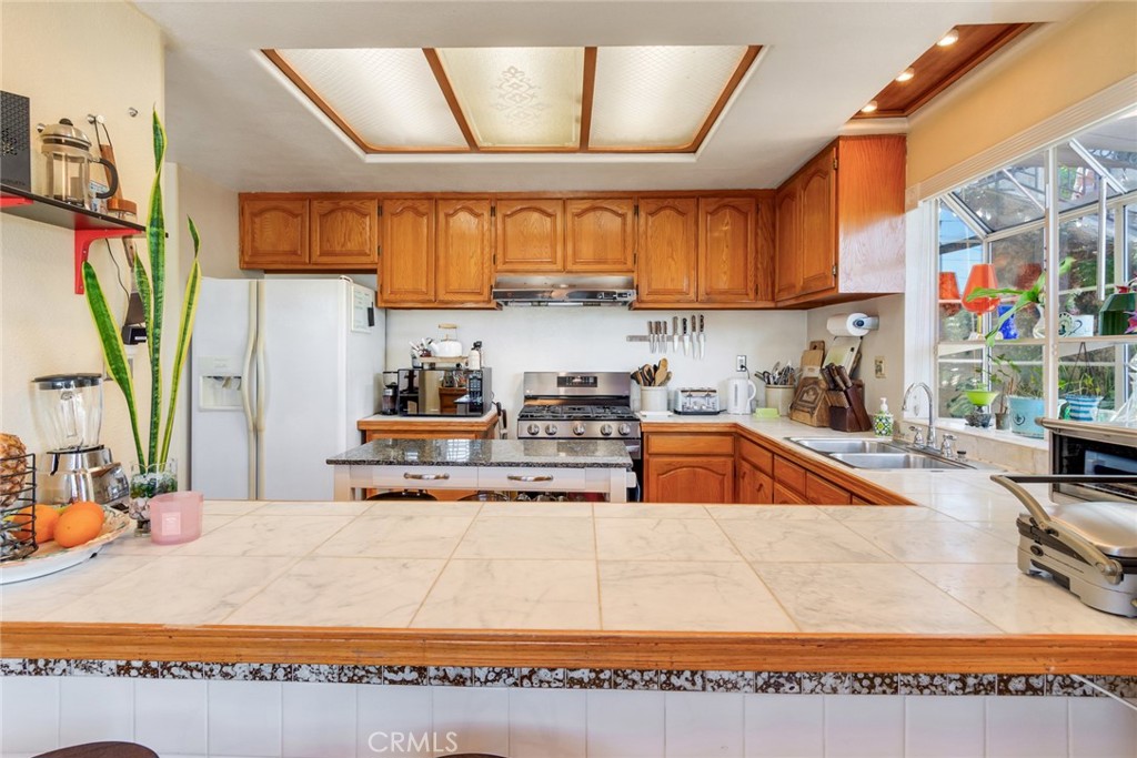 4220 Toland Way Los Angeles, CA 90065 - Photo 17 of 49 a kitchen with stainless steel appliances granite countertop a sink window and cabinets