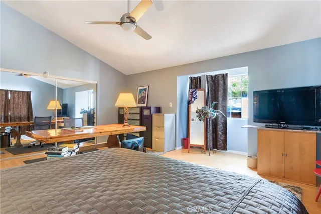 a bedroom with a large bed and a book shelf
