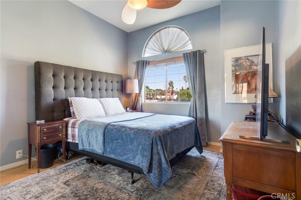 4220 Toland Way Los Angeles, CA 90065 - Photo 28 of 49 a bedroom with a bed a mirror on dresser and a large window