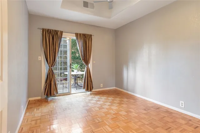a view of a chair and table in backyard of the house