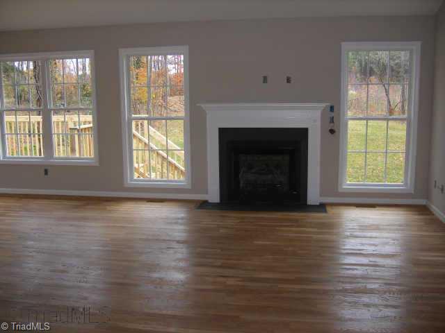 210 Link Road Reidsville, NC 27320 - Photo 6 of 7 Other. Fireplace in open great room with real hardwood floors.