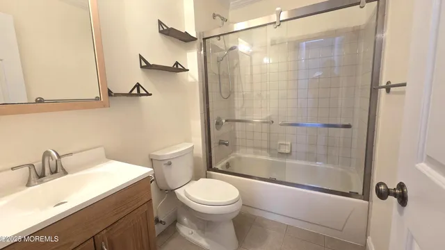 a bathroom with a shower a toilet and a sink