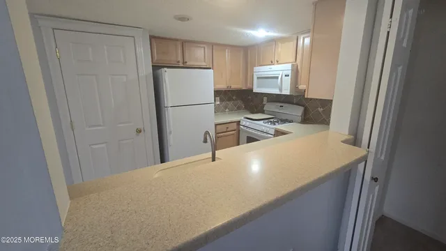 a kitchen with refrigerator and cabinets