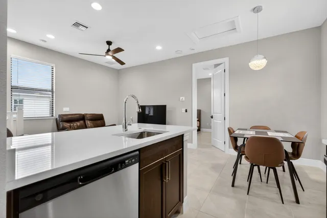 a kitchen with a table chairs sink and microwave