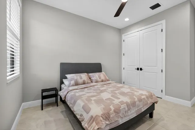 a bedroom with a bed and a window