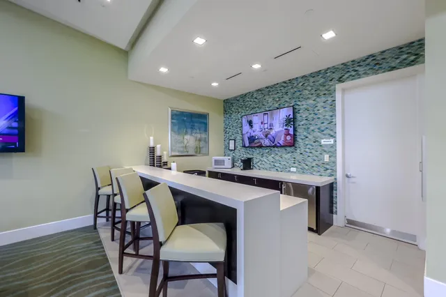 a view of kitchen with kitchen island dining table and chairs