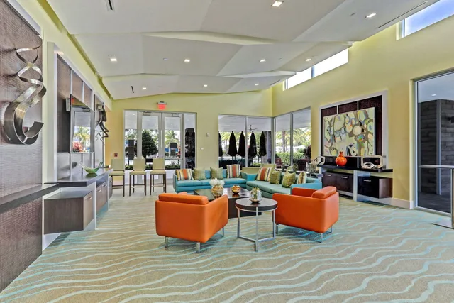 a living room with fireplace furniture and a large window