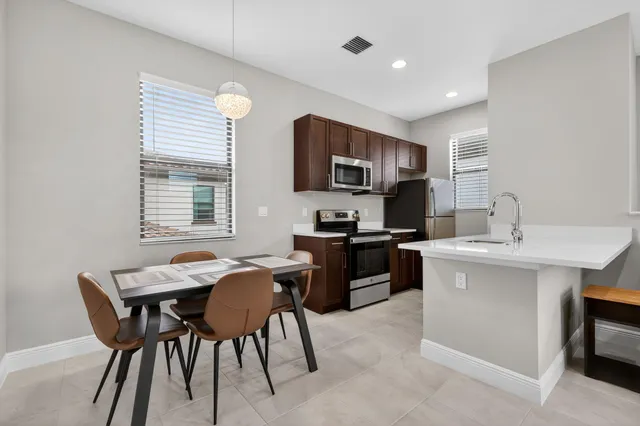 a kitchen with a dining table and chairs