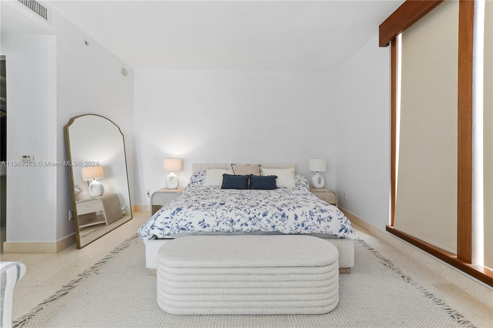 901 Brickell Key Boulevard, Unit 3504 Miami, FL 33131 - Photo 15 of 44 a room with a bed and mirror