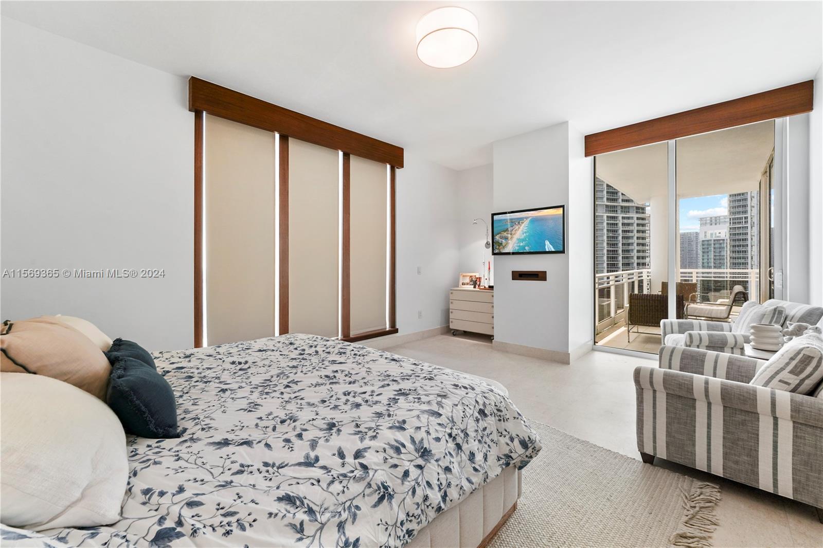901 Brickell Key Boulevard, Unit 3504 Miami, FL 33131 - Photo 16 of 44 a bedroom with a large bed and a large window