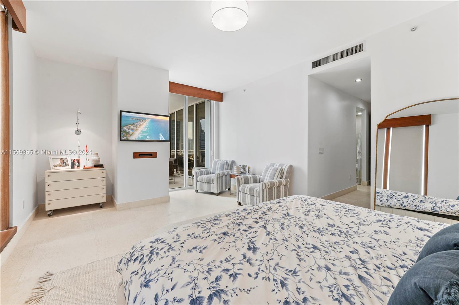 901 Brickell Key Boulevard, Unit 3504 Miami, FL 33131 - Photo 17 of 44 a bedroom with a large bed and a view of living room