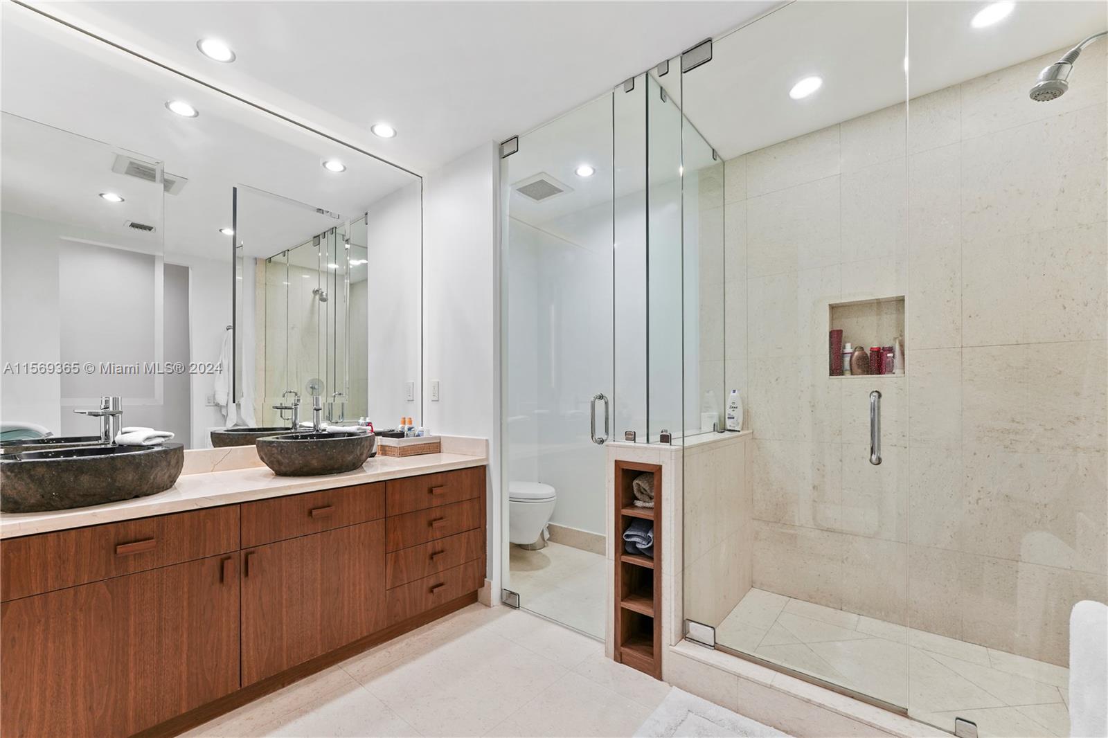901 Brickell Key Boulevard, Unit 3504 Miami, FL 33131 - Photo 18 of 44 a spacious bathroom with double vanity and a shower
