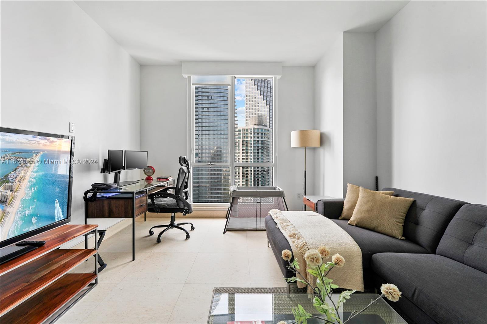 901 Brickell Key Boulevard, Unit 3504 Miami, FL 33131 - Photo 23 of 44 a living room with furniture and a flat screen tv