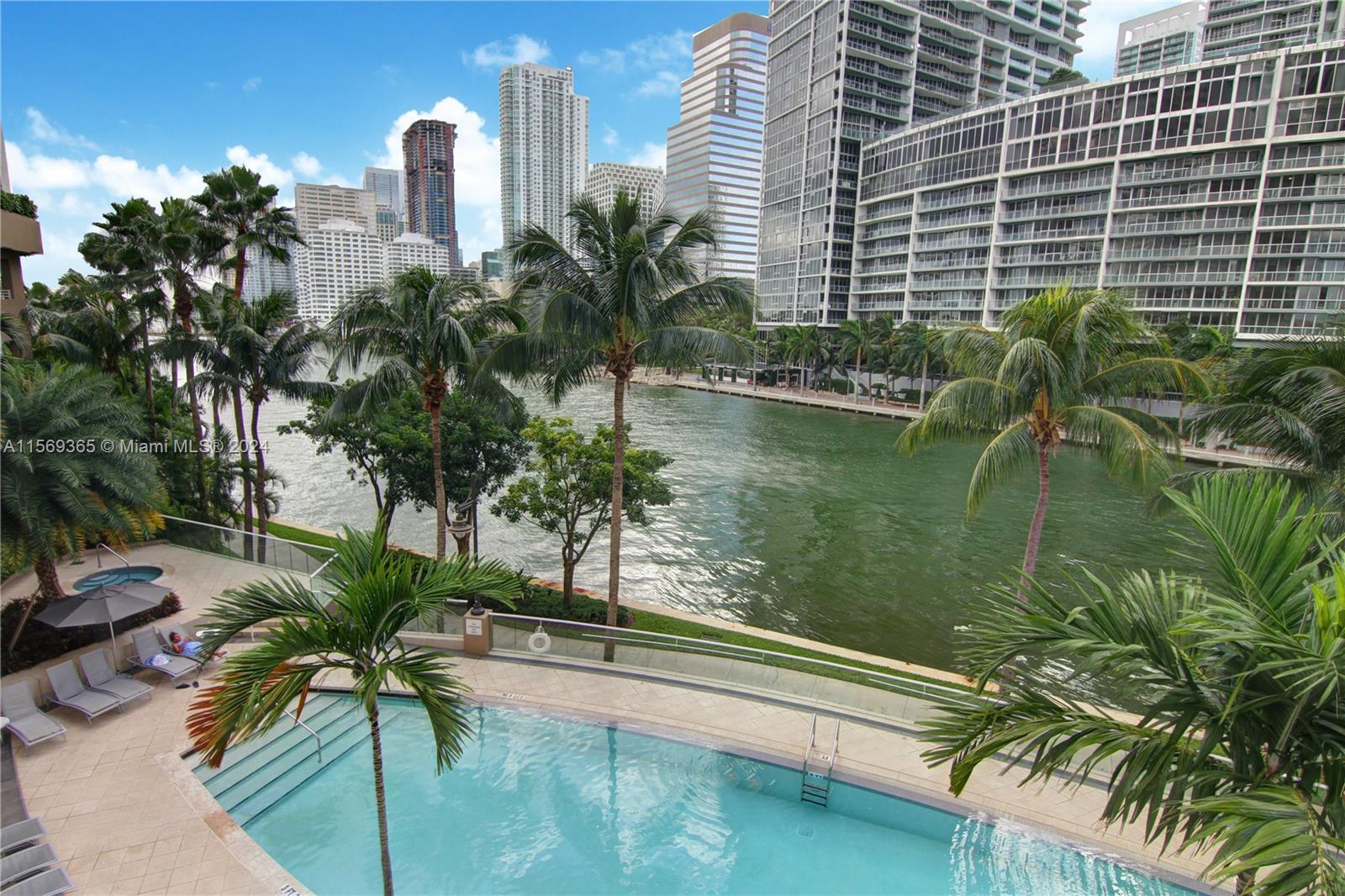 901 Brickell Key Boulevard, Unit 3504 Miami, FL 33131 - Photo 42 of 44 a lake with tall building and a palm tree