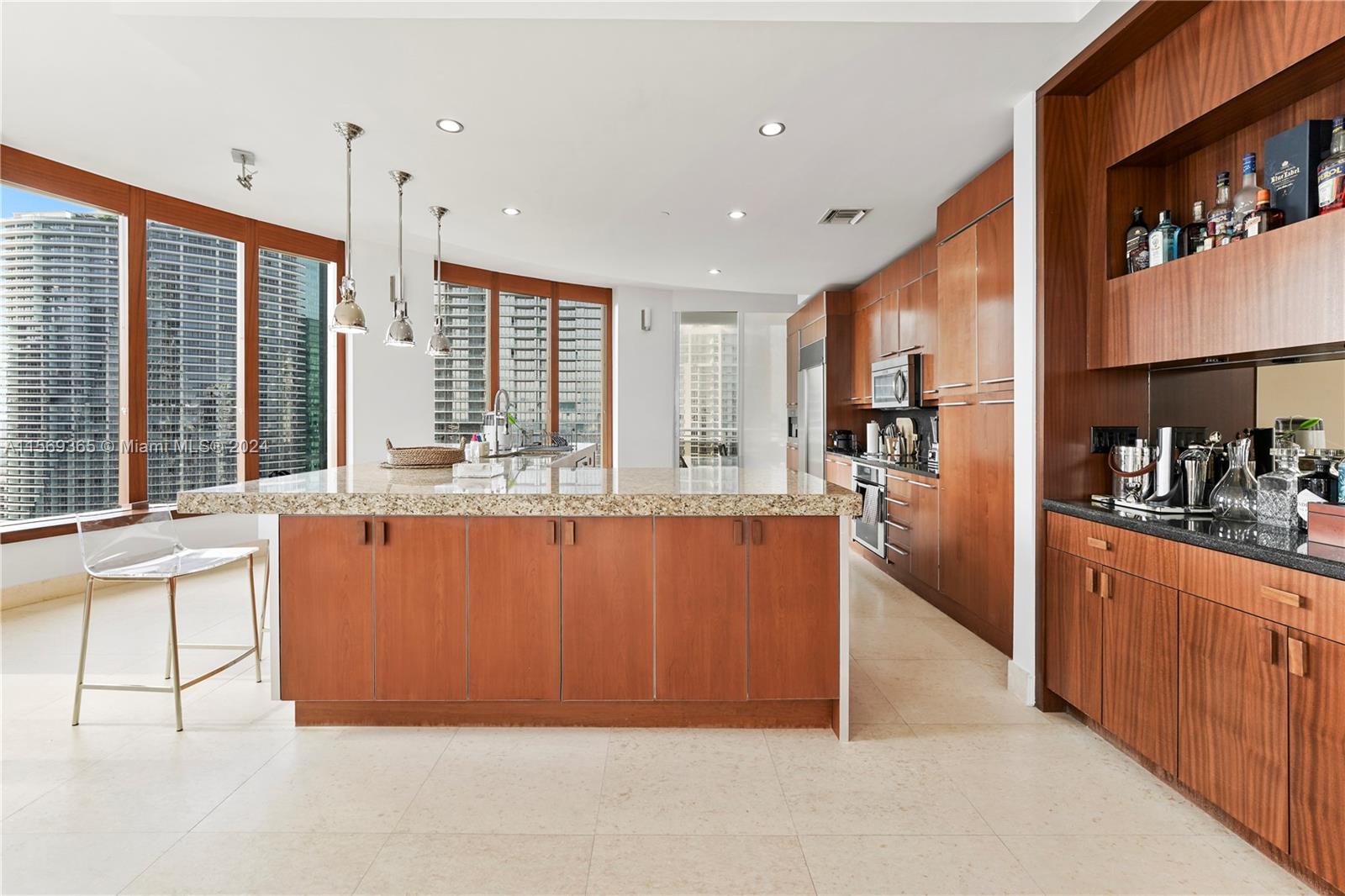 901 Brickell Key Boulevard, Unit 3504 Miami, FL 33131 - Photo 6 of 44 a large kitchen with stainless steel appliances granite countertop a refrigerator and a sink
