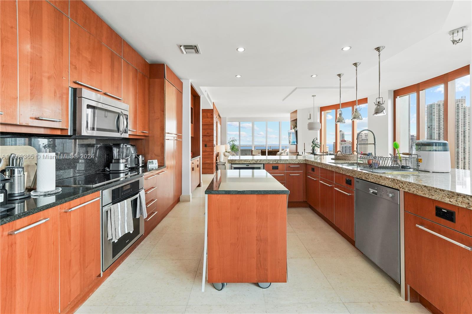 901 Brickell Key Boulevard, Unit 3504 Miami, FL 33131 - Photo 8 of 44 a large kitchen with stainless steel appliances granite countertop a stove a sink dishwasher and a refrigerator