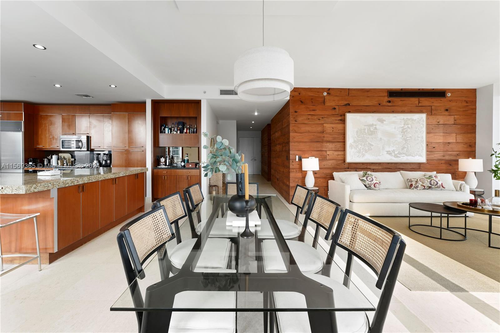 901 Brickell Key Boulevard, Unit 3504 Miami, FL 33131 - Photo 10 of 44 a view of a dining room with furniture and wooden floor