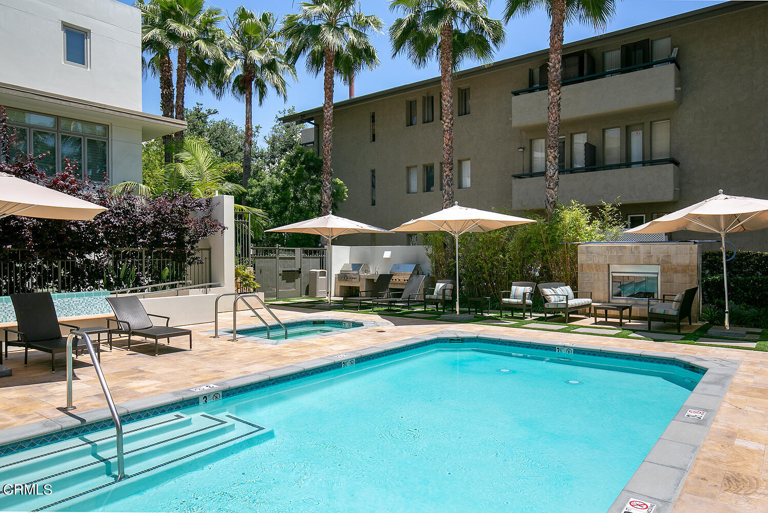 920 Granite Drive, Unit 103 Pasadena, CA 91101 - Photo 31 of 33 a patio with a table and chairs under an umbrella