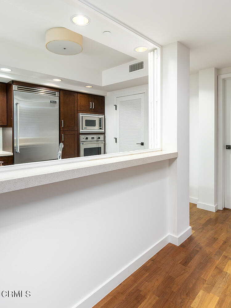 920 Granite Drive, Unit 103 Pasadena, CA 91101 - Photo 9 of 33 an empty room with wooden floor and windows