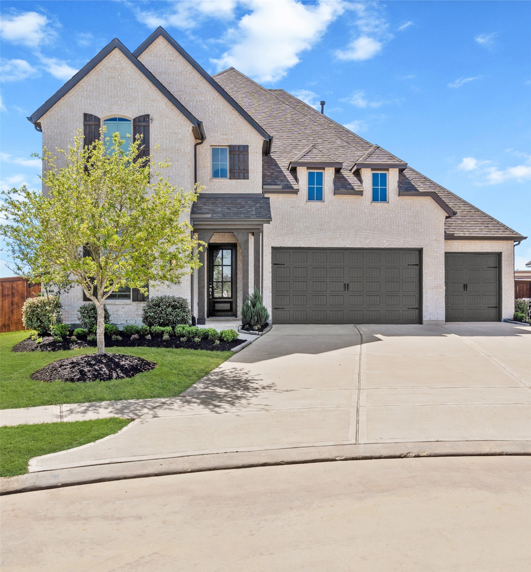 7303 Compass Drive Katy, TX 77493 - Photo 31 of 31 a front view of a house with a garden and yard
