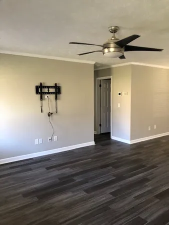 a view of a room with wooden floor
