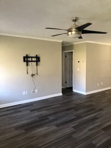 a view of a room with wooden floor