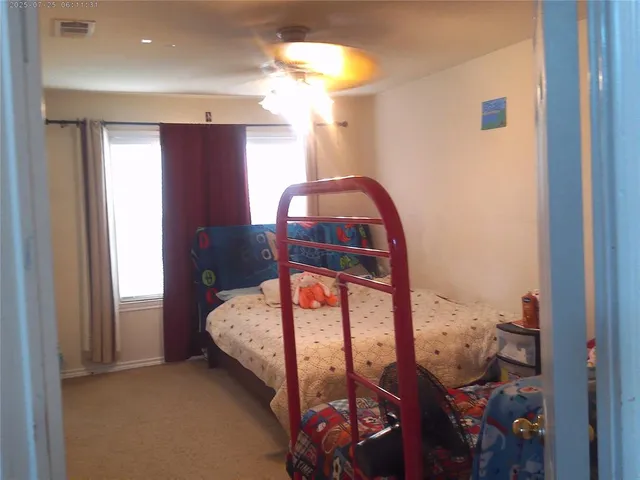 a bedroom with a bed and a mirror