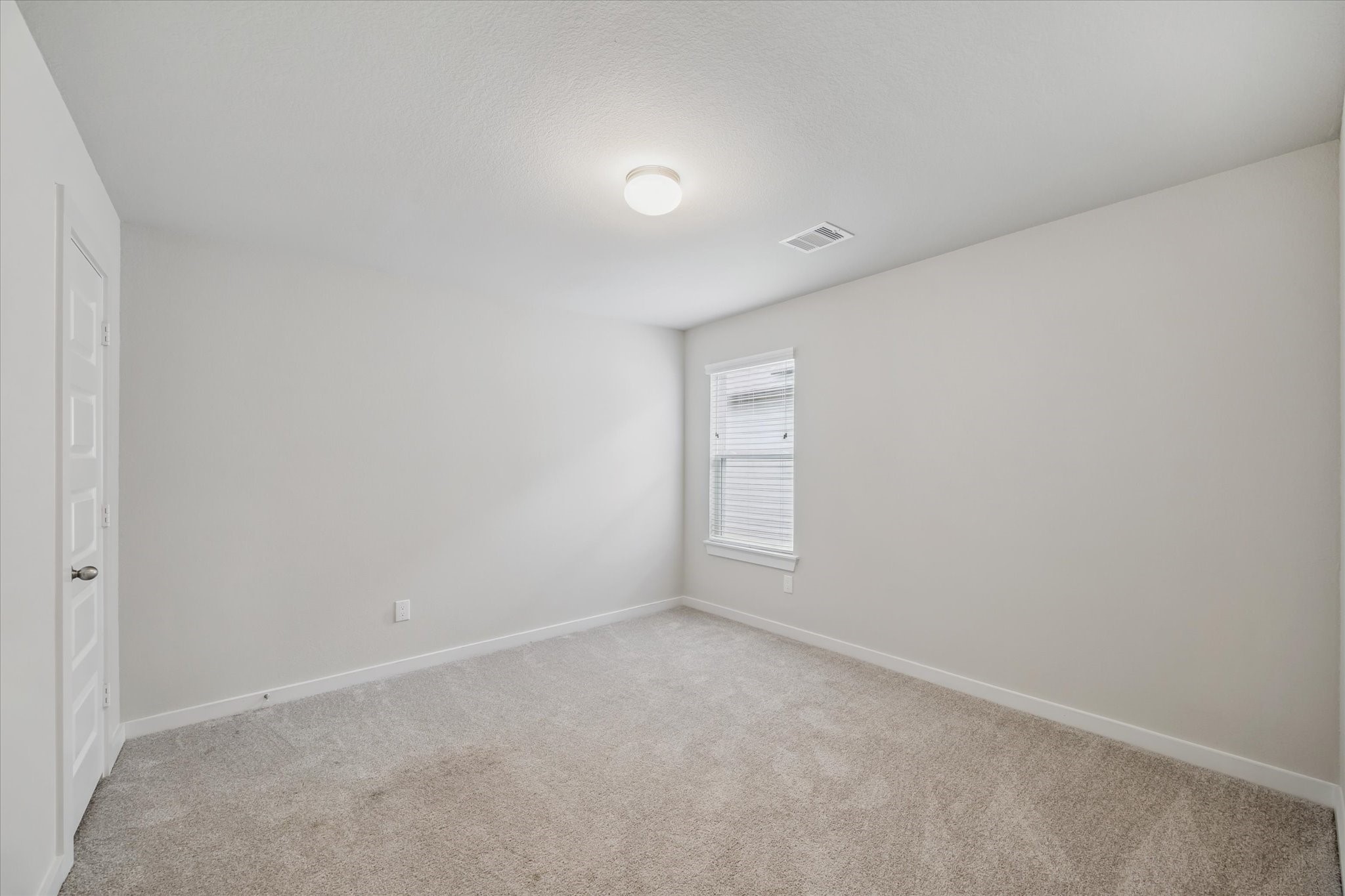 2138 Reed Cave Lane Spring, TX 77386 - Photo 17 of 23 This room is a cozy, carpeted space with neutral walls, featuring a window for natural light and a simple ceiling light fixture. Ideal for a bedroom.