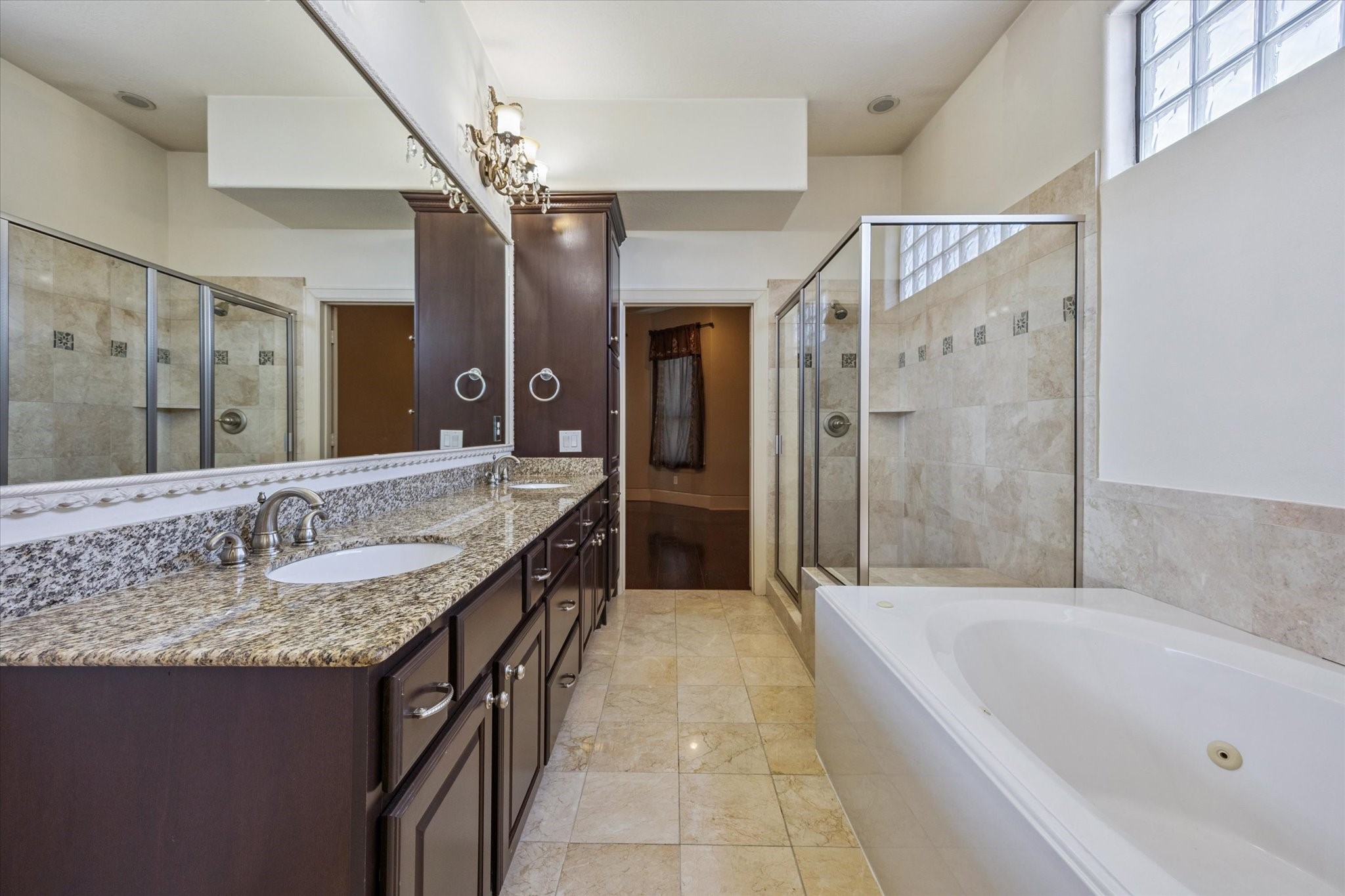 2803 Chartres Street Houston, TX 77004 - Photo 11 of 22 a bathroom with a granite countertop tub a sink and a large mirror