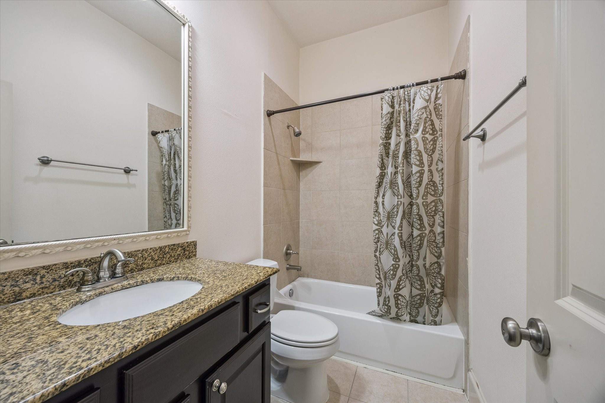 2803 Chartres Street Houston, TX 77004 - Photo 16 of 22 a bathroom with a granite countertop sink toilet and shower