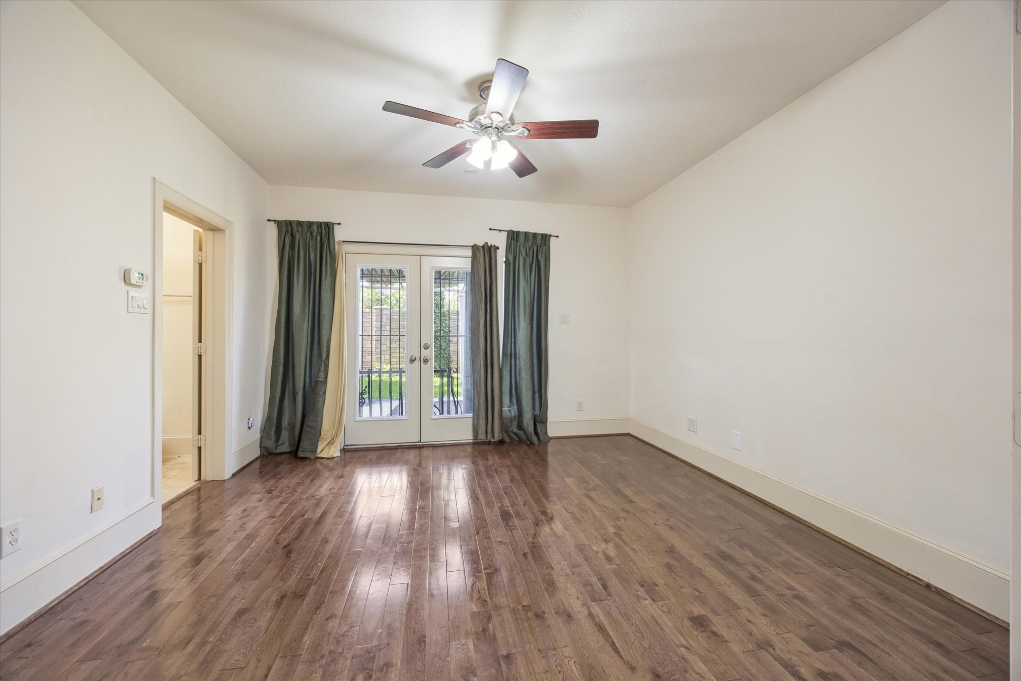 2803 Chartres Street Houston, TX 77004 - Photo 18 of 22 a view of an empty room with wooden floor and a window