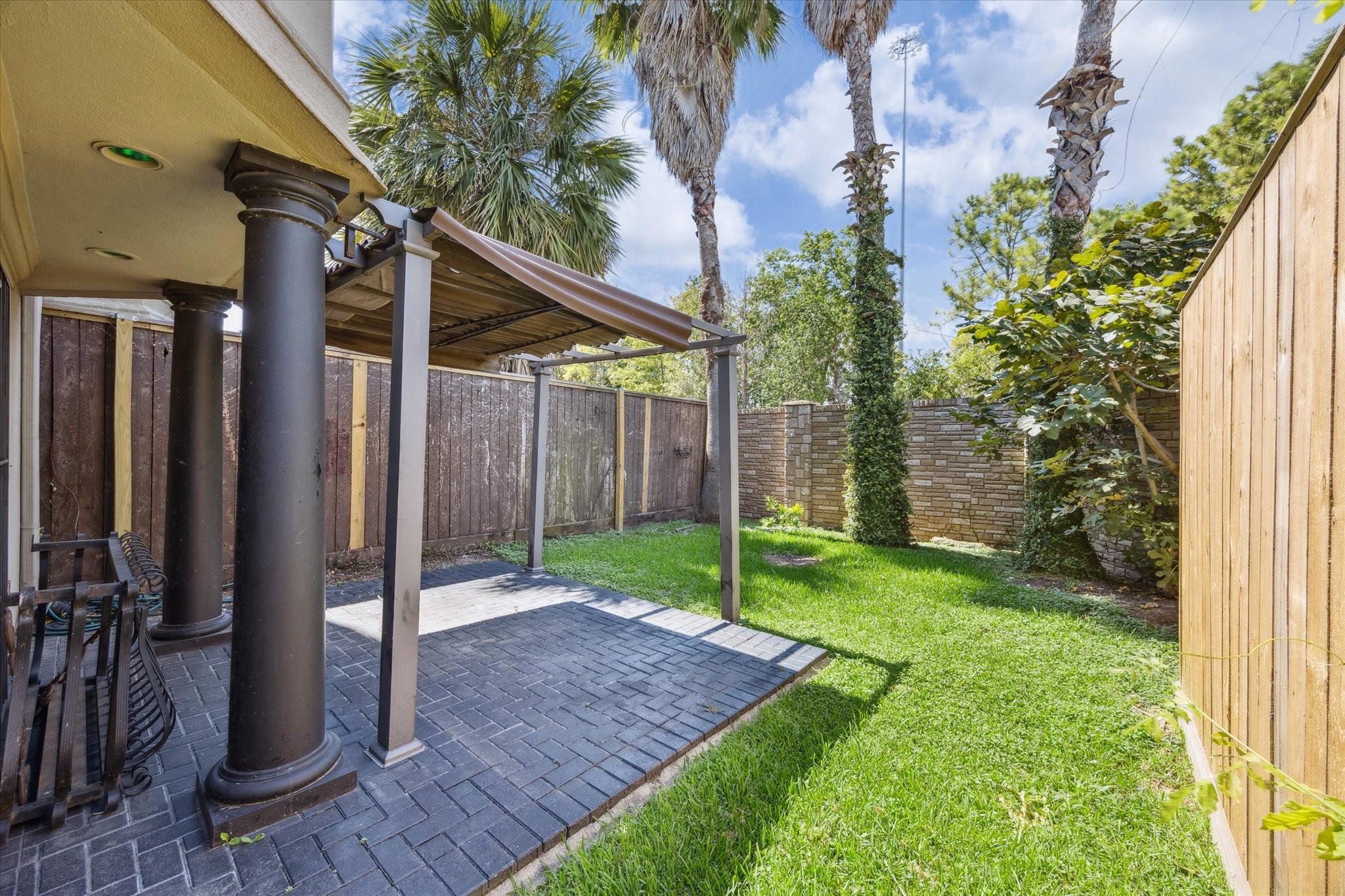 2803 Chartres Street Houston, TX 77004 - Photo 4 of 22 a backyard of a house with plants and wooden fence