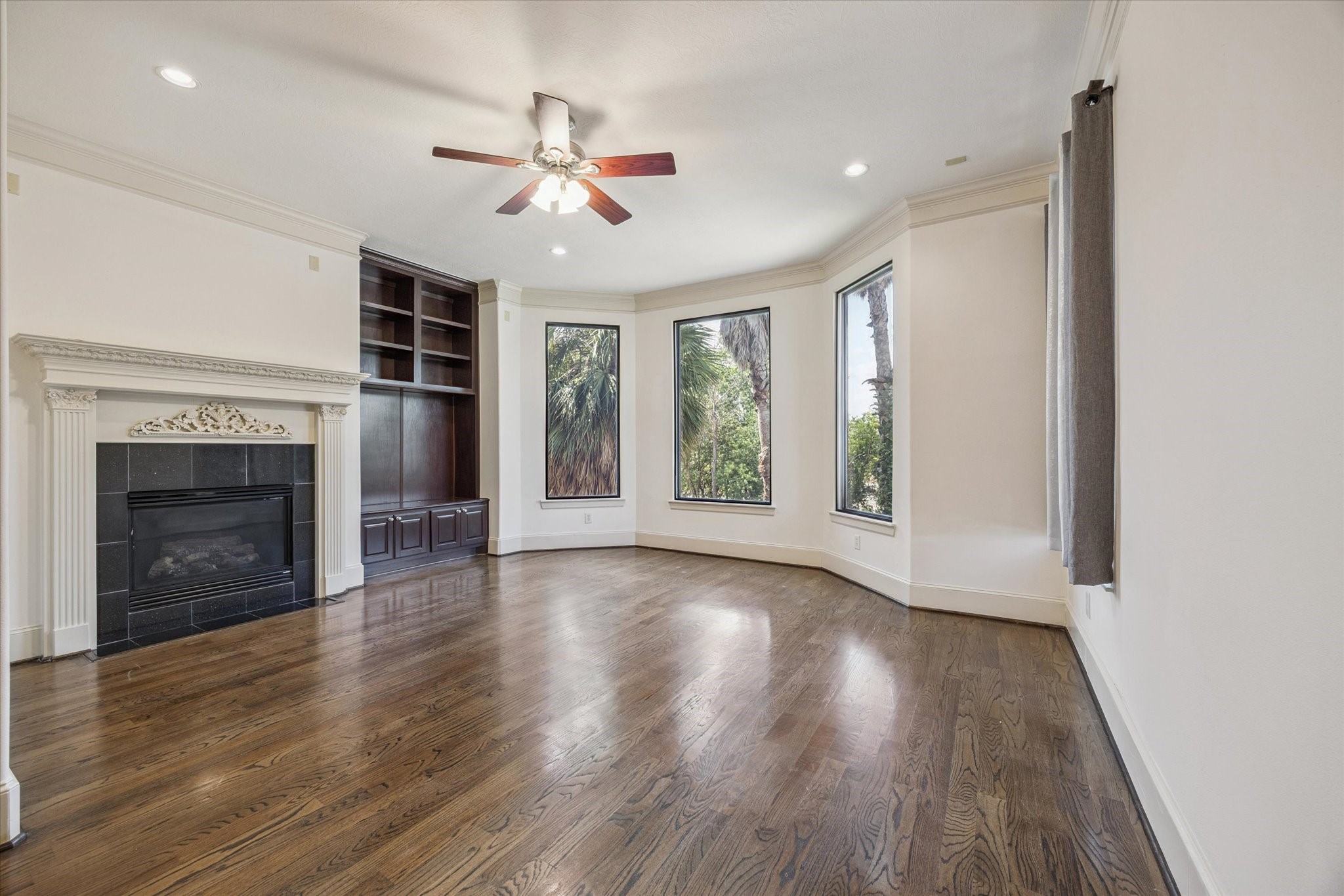 2803 Chartres Street Houston, TX 77004 - Photo 5 of 22 a view of an empty room with wooden floor fireplace and a window