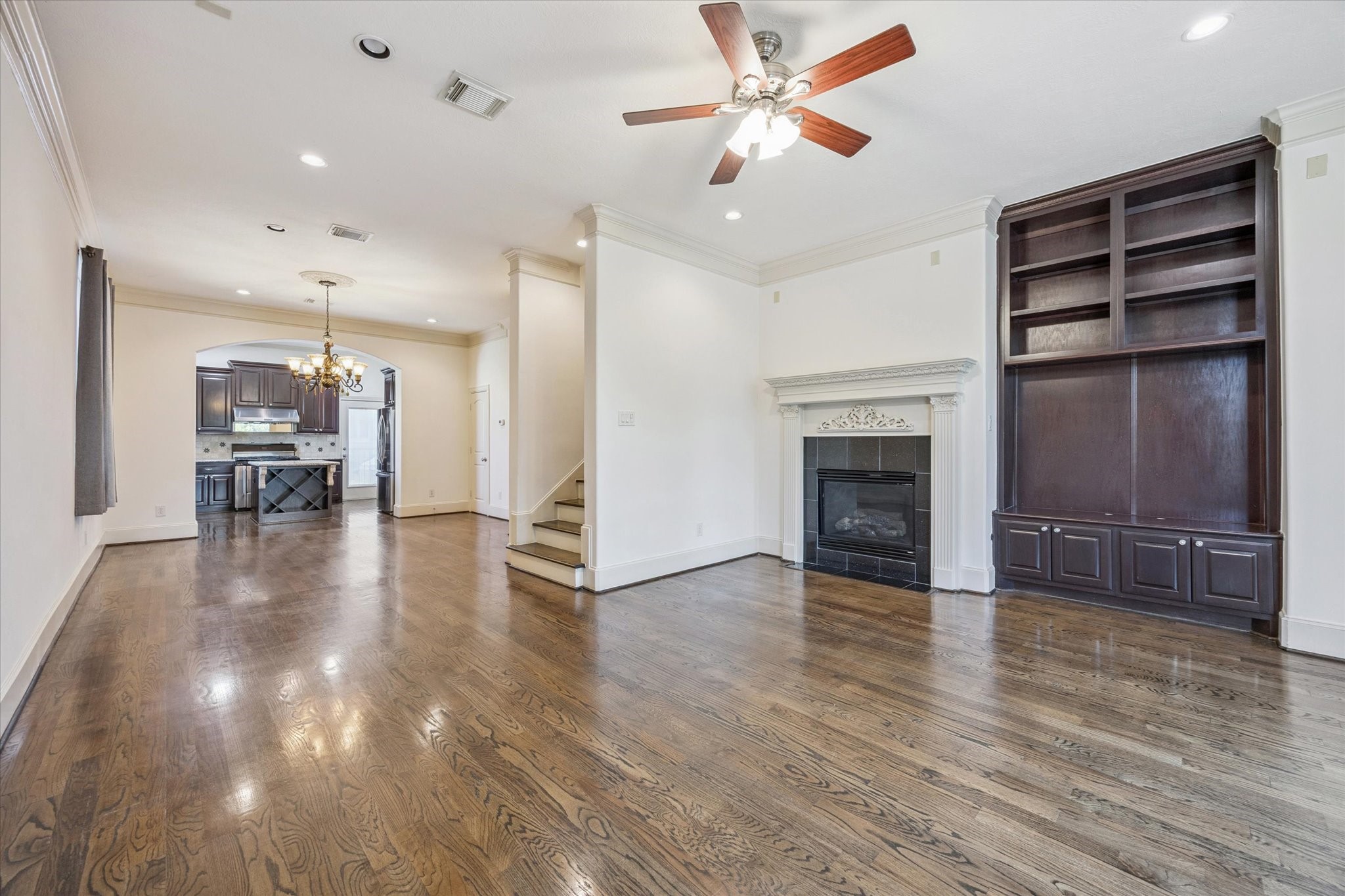 2803 Chartres Street Houston, TX 77004 - Photo 6 of 22 an empty room with wooden floor fireplace and windows