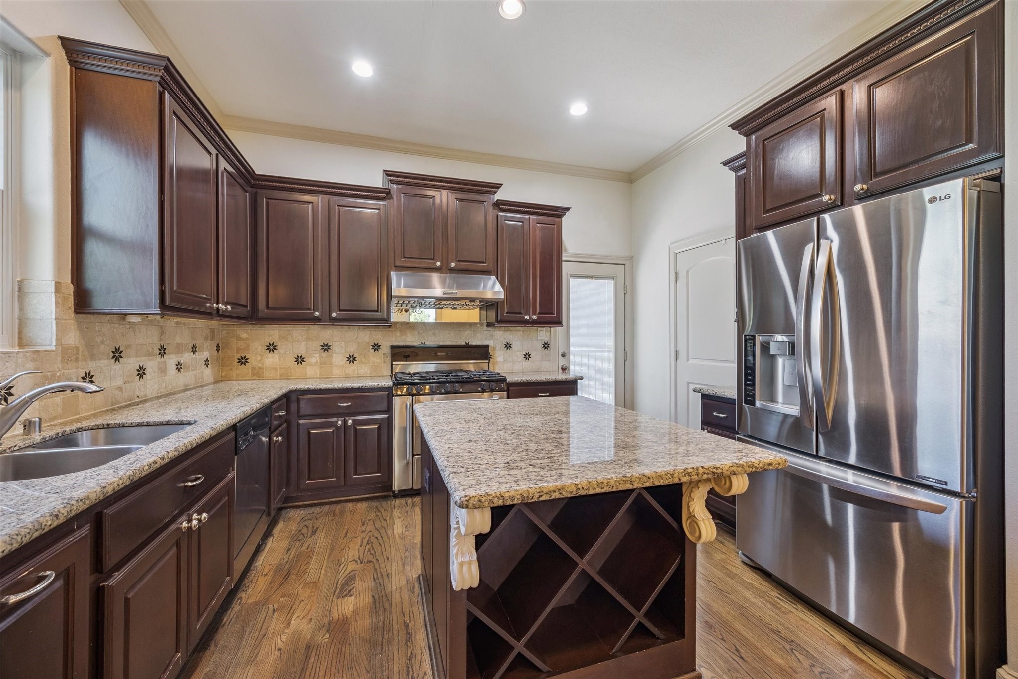 2803 Chartres Street Houston, TX 77004 - Photo 8 of 22 a kitchen with stainless steel appliances granite countertop a refrigerator stove microwave and sink