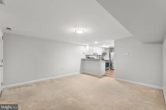 a view of a room with cabinet and a view of kitchen