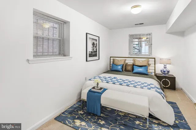 a bedroom with a bed a table and chair