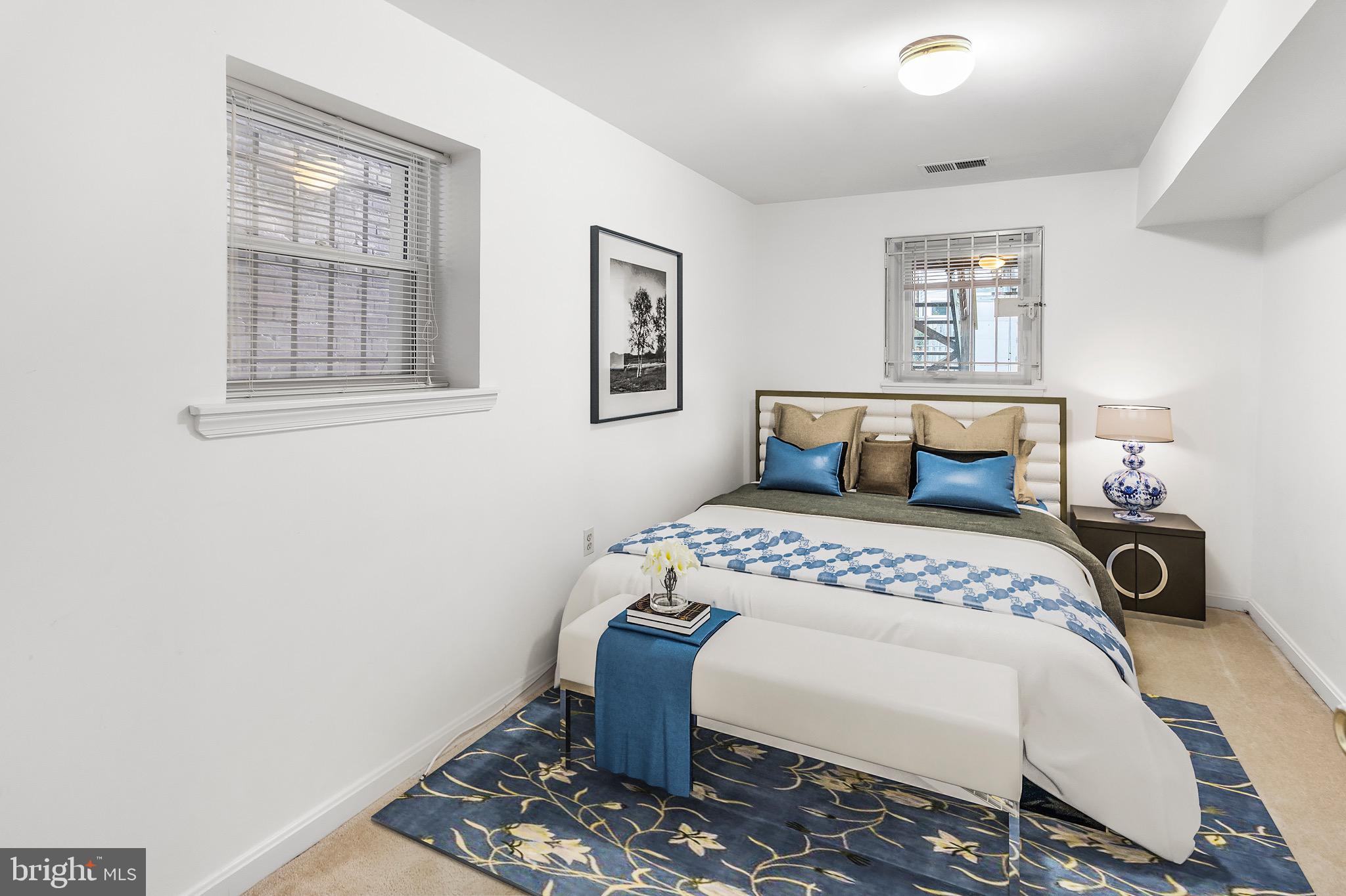 3612 Rock Creek Church Road Northwest, Unit LWR Washington, DC 20010 - Photo 14 of 19 a bedroom with a bed a table and chair