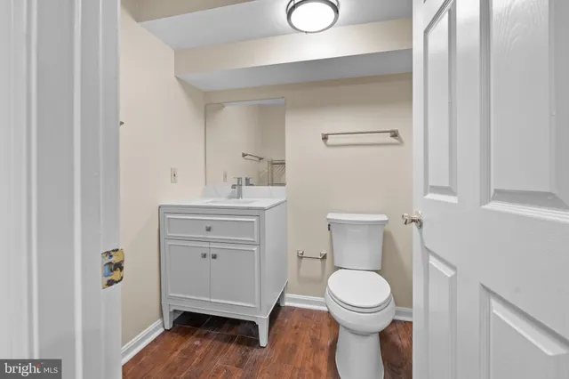 a bathroom with a toilet a sink and a mirror