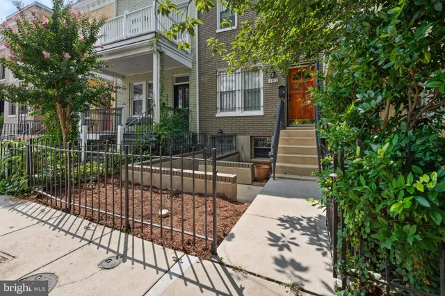 a view of a house with a iron fence