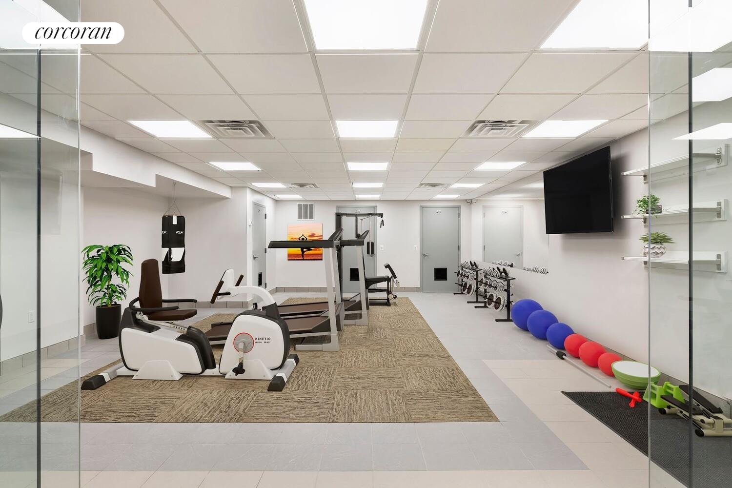 23-16 31st Avenue, Unit 4A Queens, NY 11106 - Photo 5 of 9 a living room with furniture and a flat screen tv