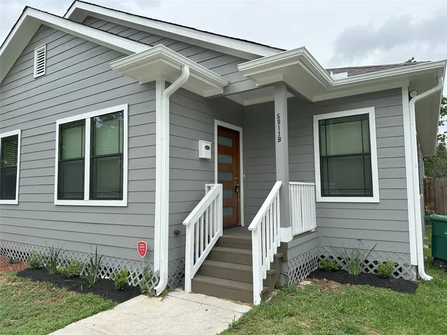 a view of a house with stairs and a yard