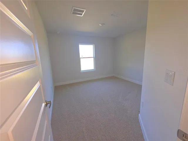 a view of an empty room and a window