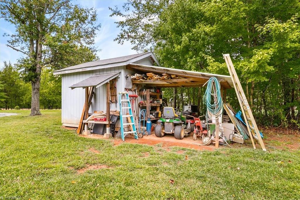 5822 Ruralview Road Gibsonville, NC 27249 - Photo 31 of 35 Storage shed with lean-to