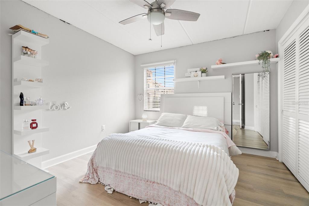 107 South Obrien Street, Unit 217 Tampa, FL 33609 - Photo 11 of 39 a bedroom with a bed and a window with wooden floor