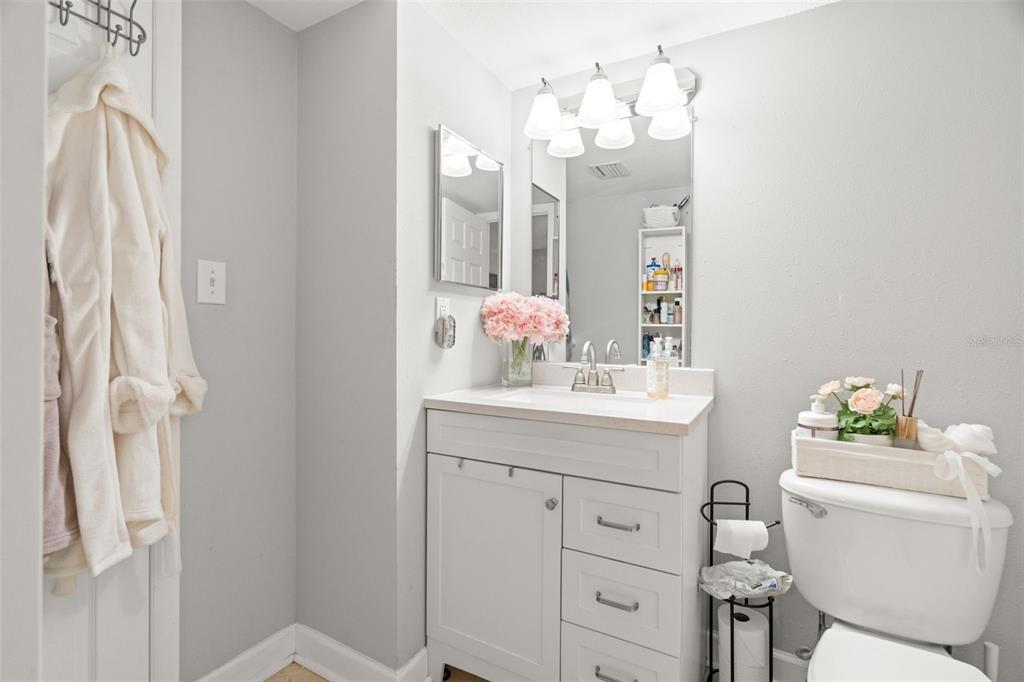 107 South Obrien Street, Unit 217 Tampa, FL 33609 - Photo 13 of 39 a bathroom with a sink vanity mirror and toilet