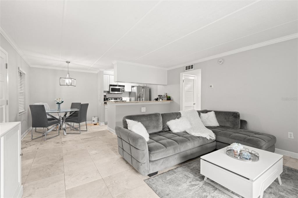 107 South Obrien Street, Unit 217 Tampa, FL 33609 - Photo 17 of 39 a living room with furniture and view of kitchen