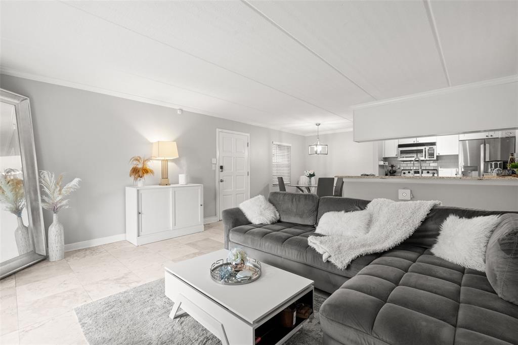 107 South Obrien Street, Unit 217 Tampa, FL 33609 - Photo 19 of 39 a living room with furniture and view of kitchen